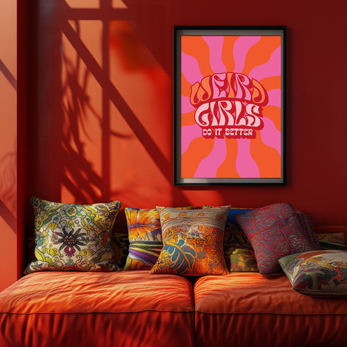 Retro-style poster with psychedelic 1970s-inspired design. Text reads "WEIRD GIRLS DO IT BETTER" in wavy, groovy lettering. Pink and orange sunburst background. Centered text surrounded by curved rays. Bold red frame with scalloped edges. Vibrant colors and playful typography create a vintage hippie vibe. Square format print with rounded corners. Perfect for fans of retro aesthetics and empowering slogans.